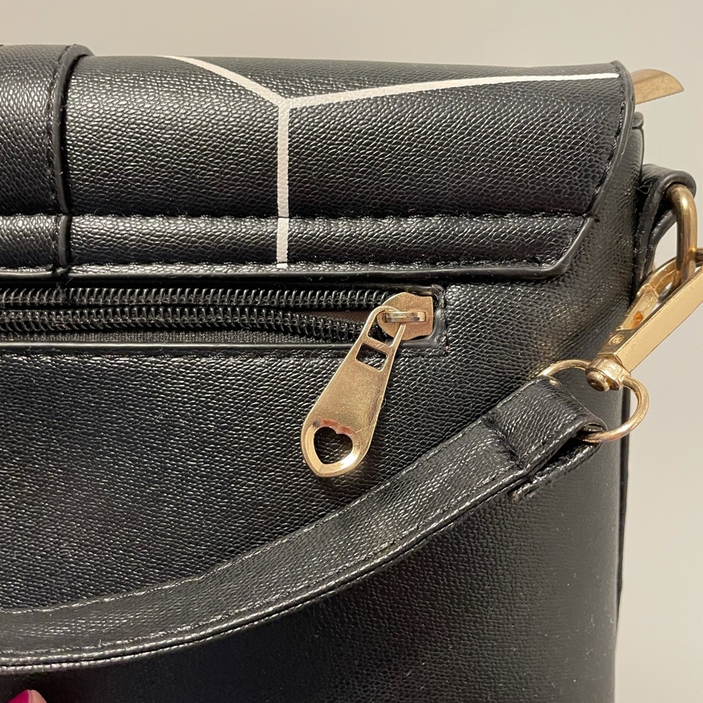 Black crossbody bag with white stripes